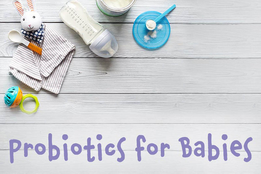 Baby toys and care items layed out with the words "probiotics for babies"